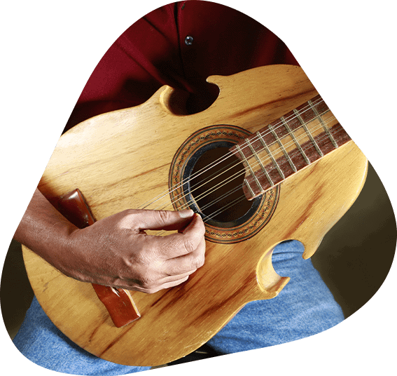 Cuatro Music Lessons A mature guy playing the guitar.